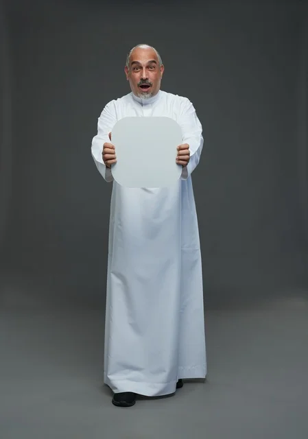 Surprised Saudi Man Holding Blank White Sign in Studio