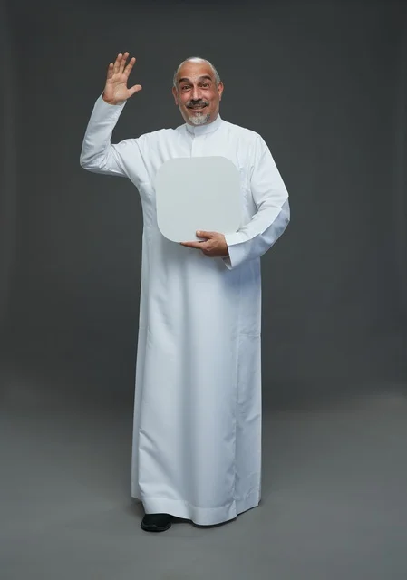 Elderly Saudi Man Waving and Holding Blank Board