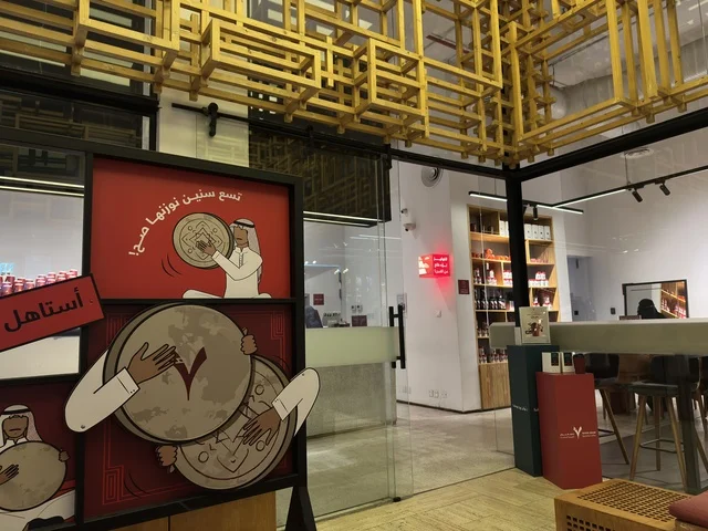 Modern Cafe Interior with Yellow Geometric Ceiling