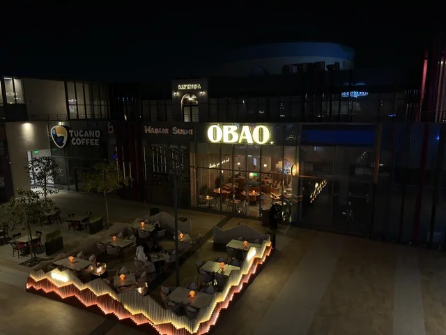 Modern Outdoor Dining Plaza and Restaurants at Night