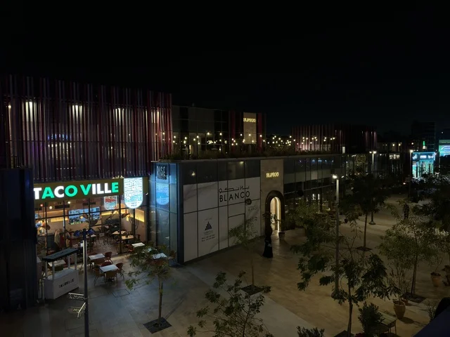 Modern Commercial Complex at Night with Neon Signs