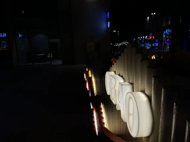 Illuminated OBAO Restaurant Sign in Urban Night Setting