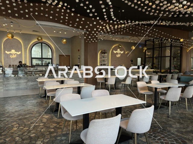 Modern Cafe Interior with White Tables and Gray Chairs