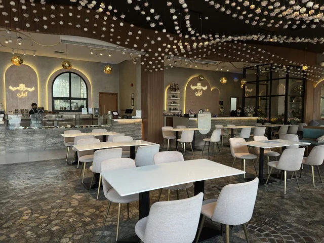 Modern Cafe Interior with White Tables and Gray Chairs