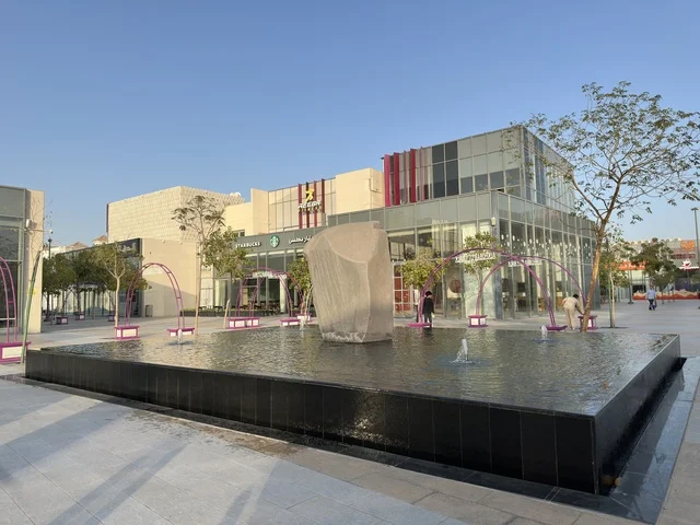 Modern Commercial Plaza with Water Fountain and Buildings