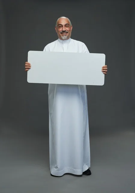 Saudi Man in Thobe Holding Blank White Board