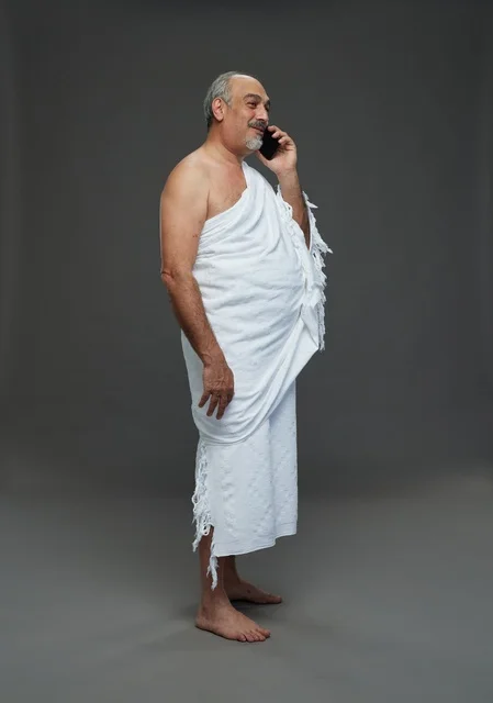 Saudi Man in Ihram Talking on Smartphone in Studio