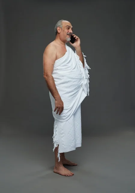 Saudi Man in Ihram Talking on Smartphone