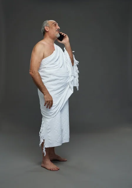 Saudi Pilgrim in Ihram Talking on Smartphone Studio