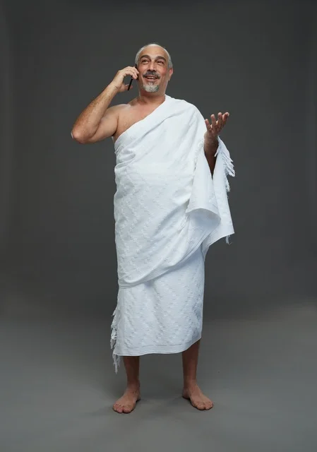 Saudi Man in Ihram Talking on Smartphone in Studio