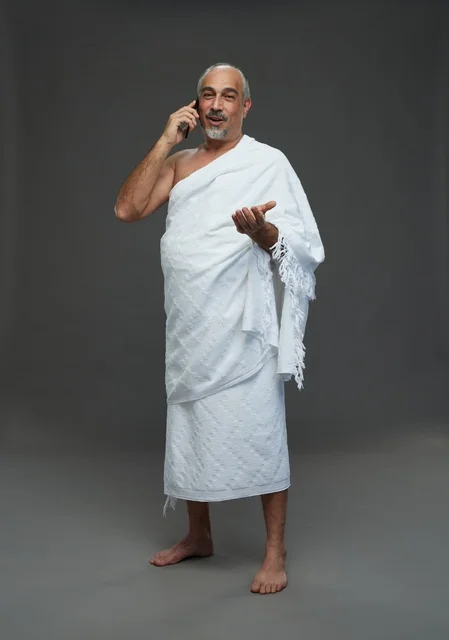 Saudi Man in Ihram Talking on Smartphone