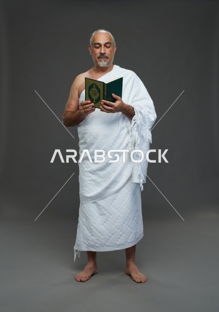 Saudi Man in Ihram Reading Holy Quran Studio Portrait