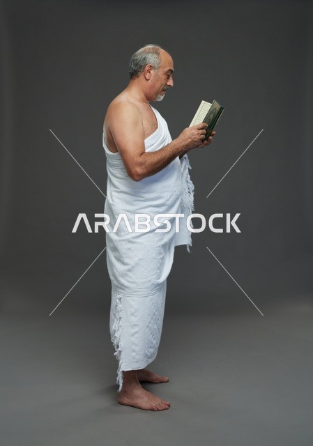 Saudi Man in Ihram Clothing Reading Holy Quran