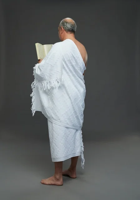 Saudi Man in Ihram Reading Quran Studio Back View