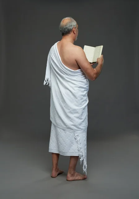 Saudi Man in Ihram Reading Holy Quran Studio Shot