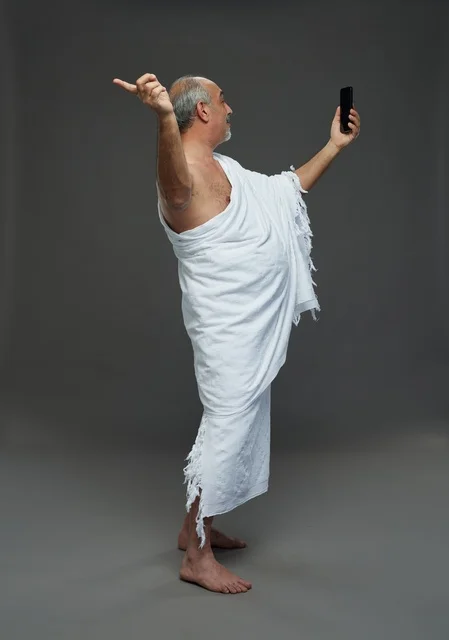 Saudi Man in Ihram Taking Smartphone Selfie