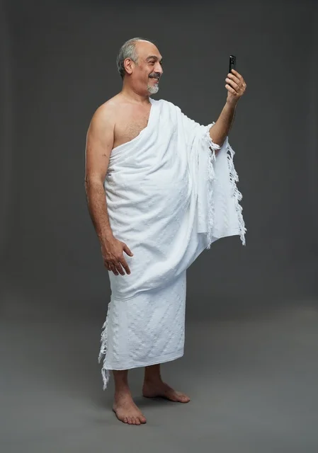 Saudi Man in Ihram Taking Selfie with Smartphone