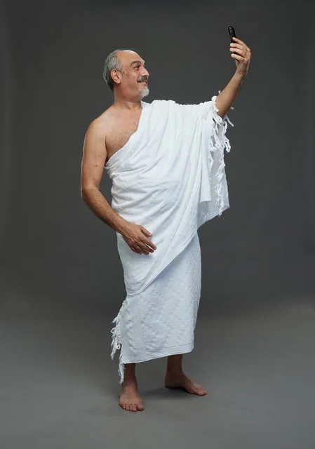 Saudi Muslim Pilgrim in Ihram Taking Selfie with Smartphone