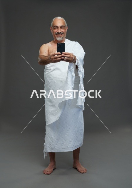 Saudi Man in Ihram Taking Selfie with Smartphone