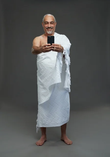 Saudi Man in Ihram Taking Selfie with Smartphone