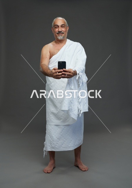 Saudi Pilgrim in Ihram Taking Selfie with Smartphone
