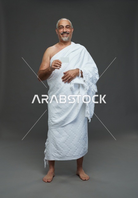 Saudi Man in Ihram Holding Blank Card Studio