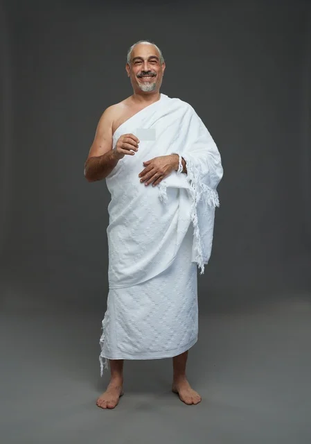 Saudi Man in Ihram Holding Blank Card Studio