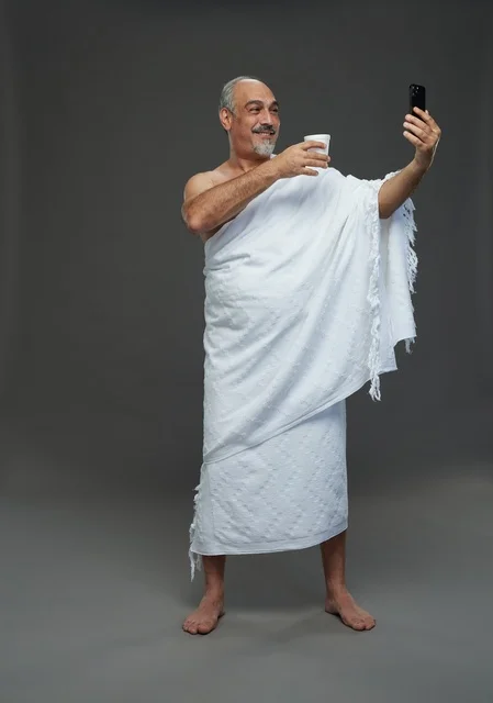Saudi Pilgrim in Ihram Taking Selfie with Smartphone