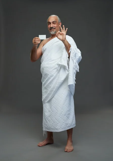 Saudi Man in Ihram Holding Blank Card and OK Sign