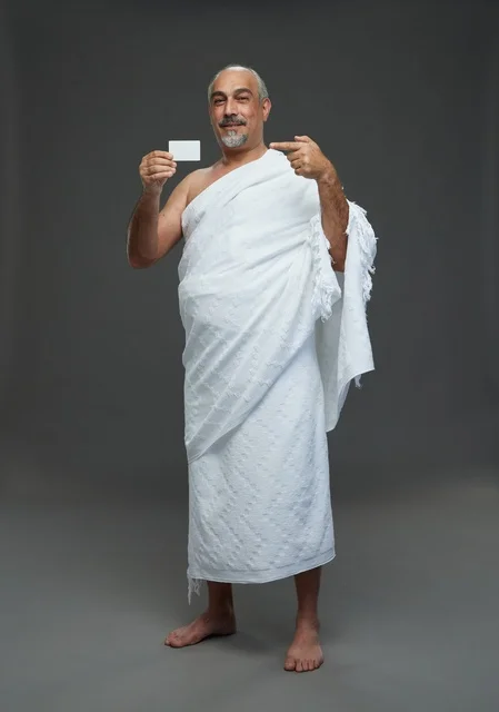 Saudi Man in Ihram Holding Blank Card Studio Portrait
