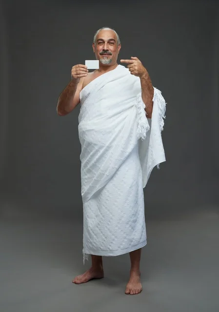 Saudi Man in Ihram Holding Blank Card Studio Shot