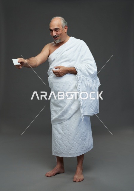 Saudi Man in Ihram Holding Blank Card Studio