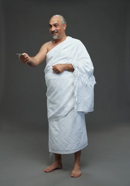 Saudi Man in Ihram Holding Blank Card Studio Shot