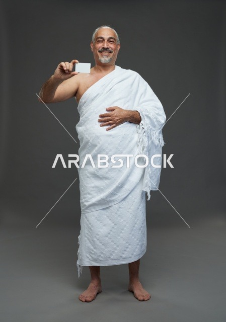 Saudi Man in Ihram Clothing Holding Blank Card Studio