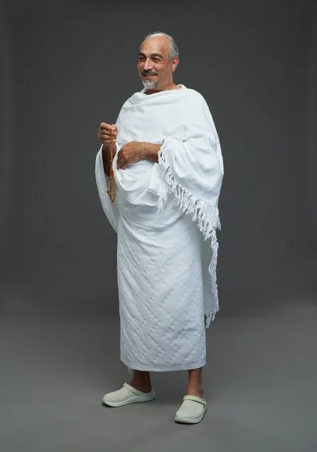 Saudi Man in Ihram Holding Prayer Beads in Studio
