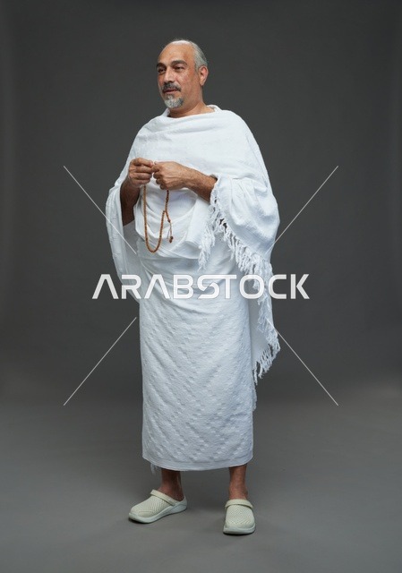 Saudi Man in White Ihram Holding Prayer Beads