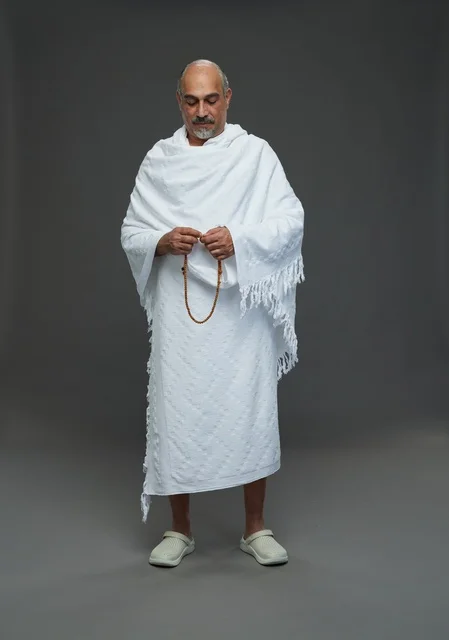 Saudi Man in White Ihram Clothing with Prayer Beads