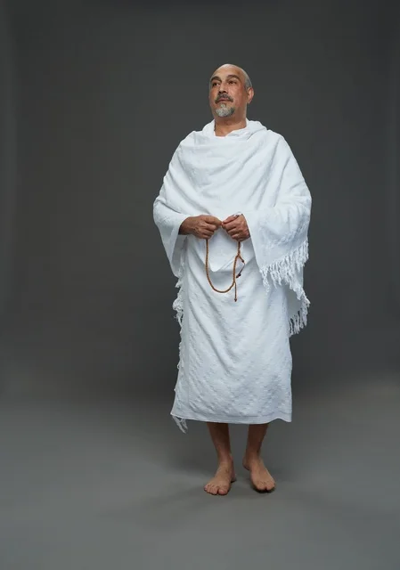 Saudi Man in Ihram Holding Prayer Beads in Studio