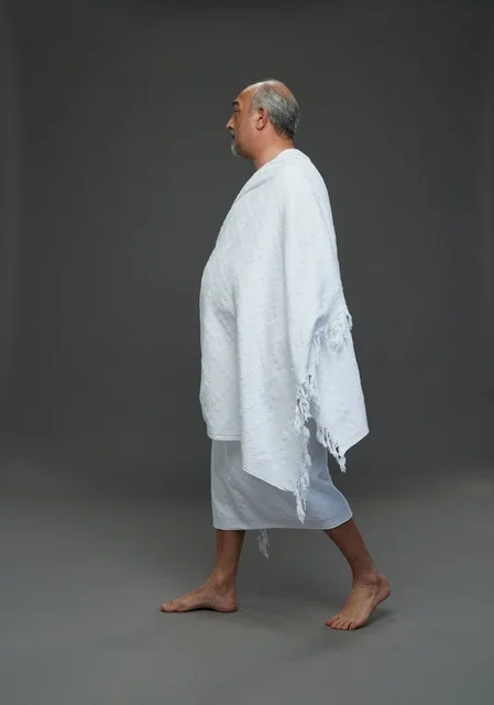 Saudi Man in Ihram Walking for Hajj and Umrah