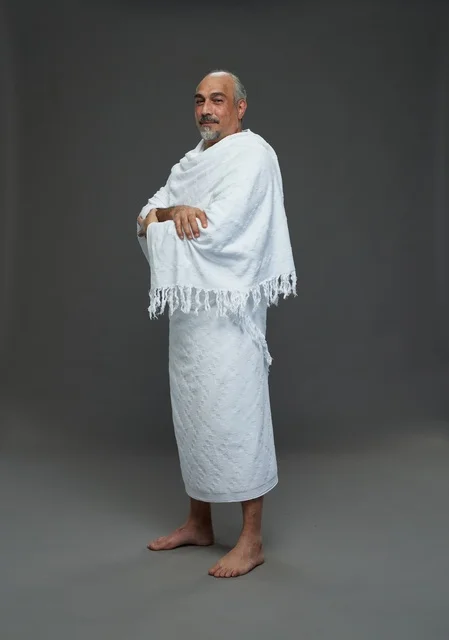 Smiling Saudi Man in White Ihram Clothing