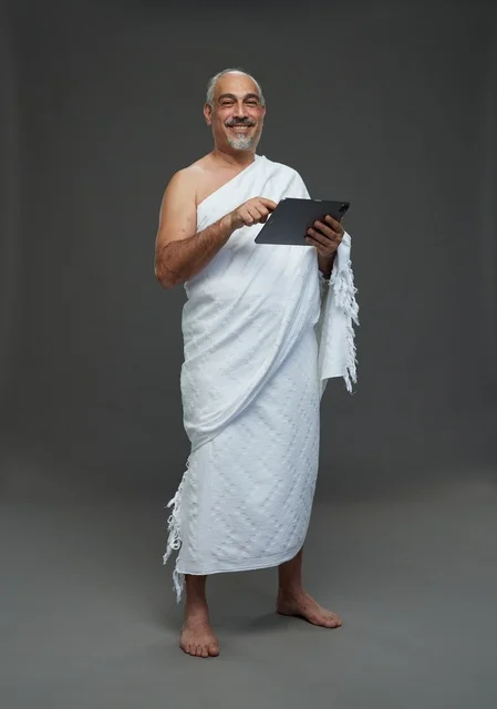 Saudi Man in Ihram Clothing Using Tablet in Studio
