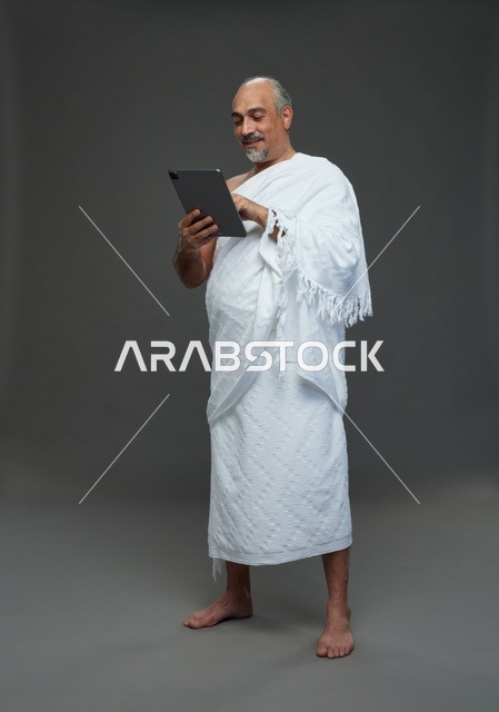 Saudi Man in Ihram Using Digital Tablet Studio