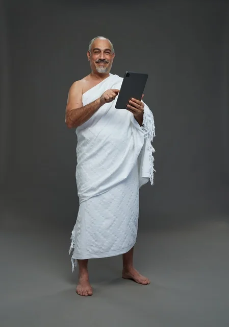 Saudi Man in Ihram Using Digital Tablet