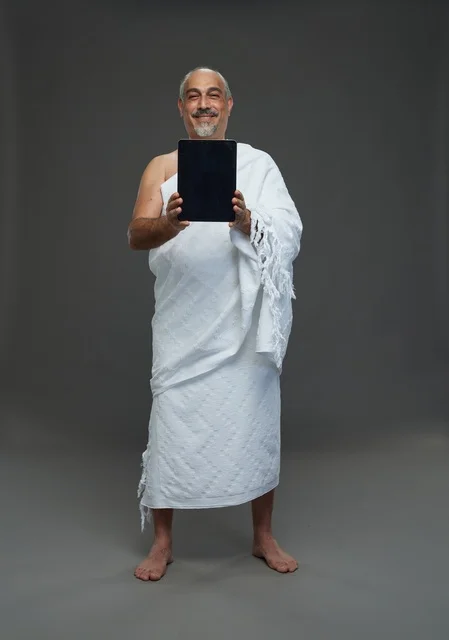 Saudi Man in Ihram Holding Tablet Blank Screen