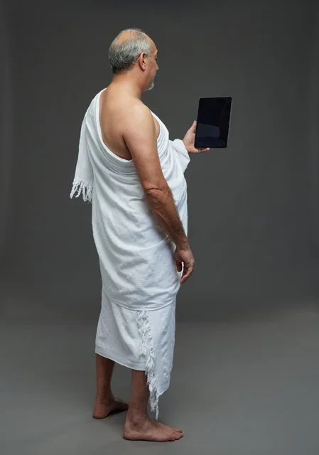 Saudi Man in Ihram Using Tablet in Studio