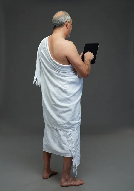 Saudi Man in Ihram Using Tablet in Studio