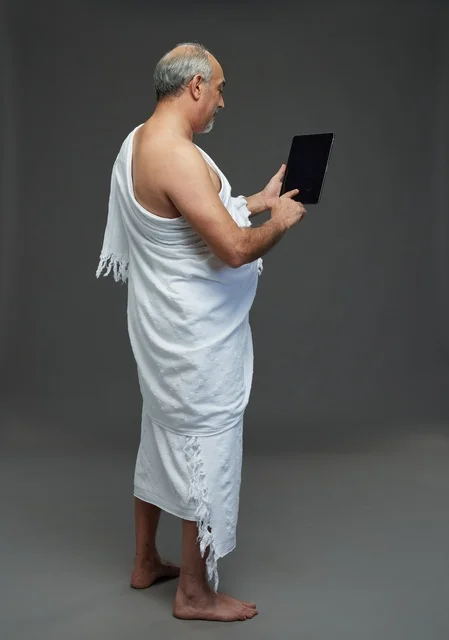 Saudi Man in Ihram Using Digital Tablet Studio