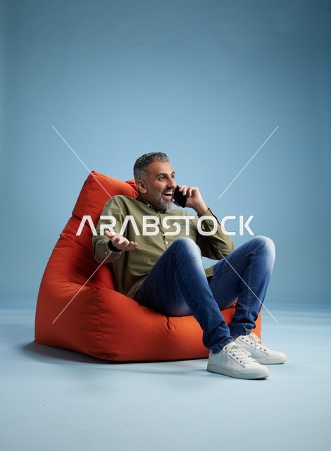 Saudi Man Talking on Mobile Phone in Bean Bag Chair