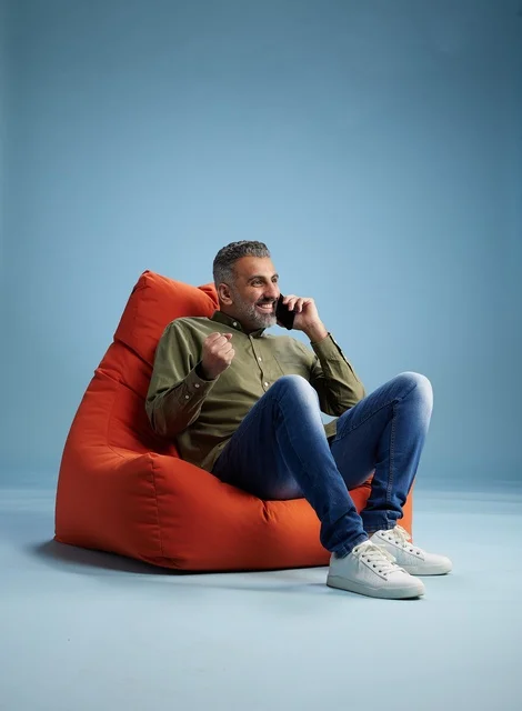 Saudi Man Talking on Smartphone on Beanbag Chair