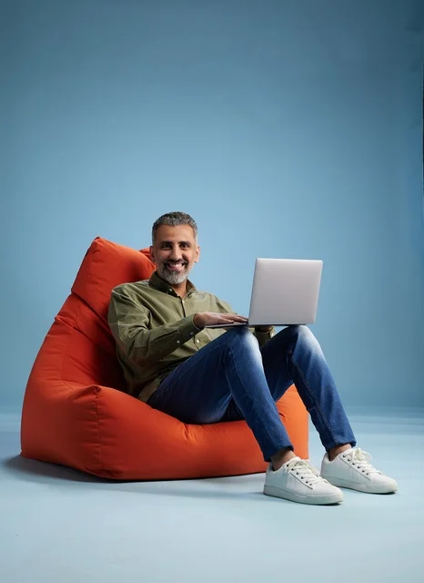 Saudi Man Using Laptop in Bean Bag Chair